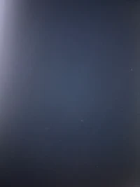 a picture of a plane flying over a dark sky