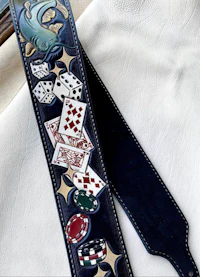 a guitar strap with poker chips and cards on it