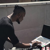 a man using a laptop on a balcony