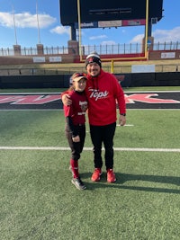 a man and a woman standing on a softball field
