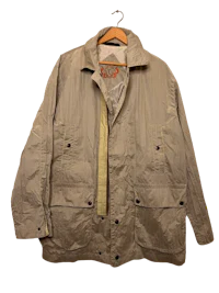 a beige jacket hanging on a hanger