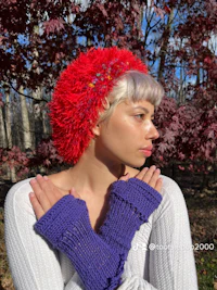 a woman wearing a red hat and purple gloves