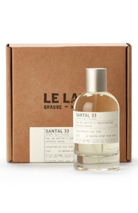 a bottle of cologne with a box in front of it
