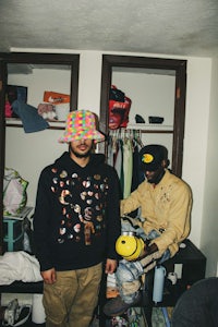 two men standing next to each other in a room