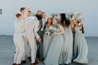 a group of bridesmaids and groomsmen posing for a photo