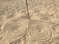 a sand sculpture with spirals in the sand