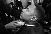 a man getting his hair cut in a barber shop