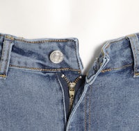 a close up of a pair of blue jeans with a zipper