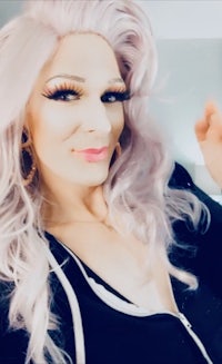 a woman with long blonde hair posing for a selfie