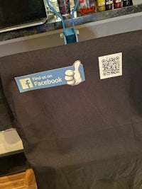 a black t - shirt with a qr code on it