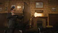 a man in a suit is holding an umbrella