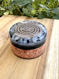 a black and brown box with a spiral design on it