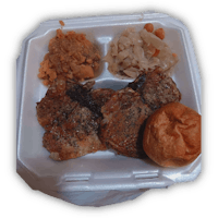 a white plate with meat, vegetables and bread