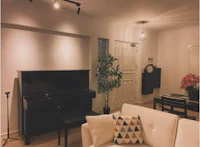a white couch and piano in a living room