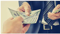 a businessman handing out money to another person