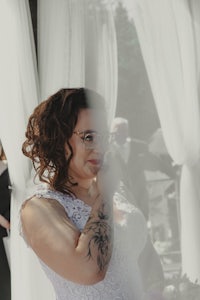 a bride in a wedding dress with tattoos