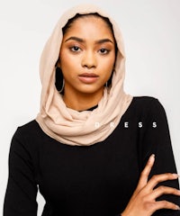 a woman wearing a beige hijab