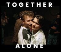 two people hugging in front of a crowd with the words together alone