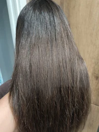 the back of a woman with long brown hair