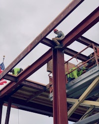 a man is working on a metal structure