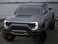 a gray pickup truck is parked near the water