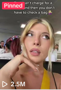 a woman in a yellow shirt is looking at her phone