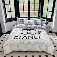 a bed with chanel bedding on it