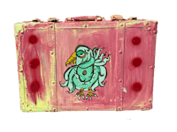 a pink suitcase with a bird painted on it