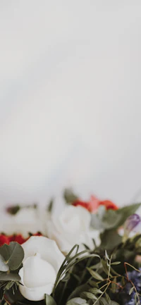 a bouquet of red, white and blue flowers