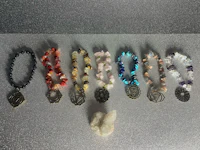 a group of bracelets with different stones and crystals