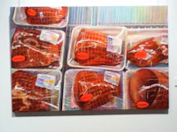 a painting of meat in plastic containers on a wall