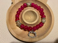 hello kitty bracelet in a wooden tray