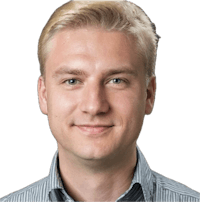 a man in a striped shirt is smiling for the camera