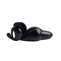 a black figurine of an elephant laying down on a white surface