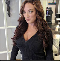 a woman posing for a photo in a hair salon