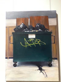 a painting of a trash can on a wall