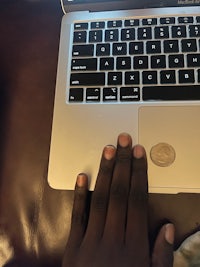 a person's hand on a laptop