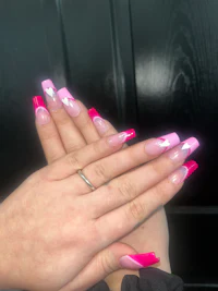 a woman's hands with pink and white nails