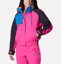 a woman wearing a pink and blue ski jacket