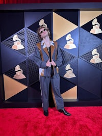 a man standing on the red carpet at the grammy awards