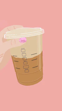 a person's hand holding a cup of coffee