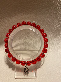 a mirror with red beads on it