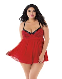 a plus size woman wearing a red lace lingersuit
