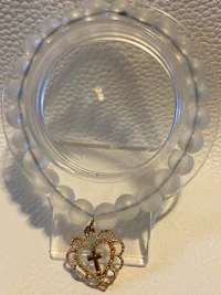 a clear bead holder with a gold ring on it
