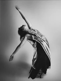 a black and white photo of a woman in a dress