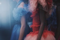 a woman in a blue dress and a woman in a red dress