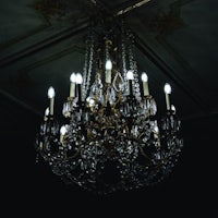 an ornate chandelier hanging in a dark room