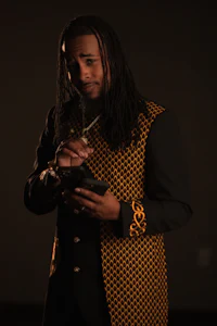 a man with dreadlocks holding a cell phone