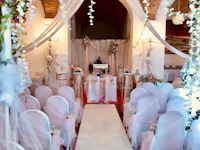 a wedding ceremony set up with white and pink decorations