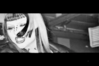 a black and white photo of a woman with lipstick on her face